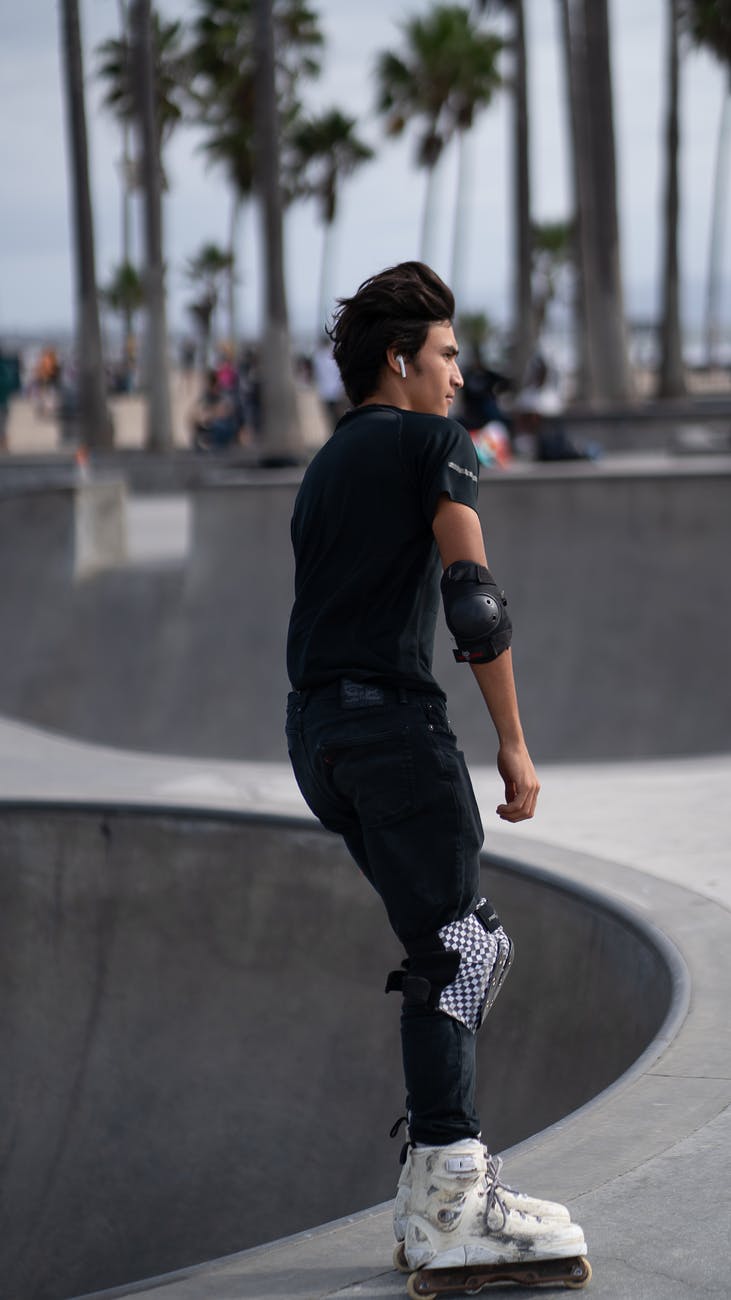 sportsman riding skateboard in skate park